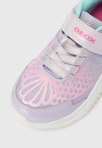 Light purple children's sneaker with glittery pink shell design, silver laces, and a Velcro strap labeled "GEOX" in pink.