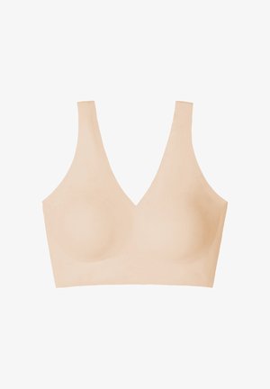 Vaaleanbeige langaton rintaliivi V-pääntiellä, pehmeällä tekstuurilla ja muotoilluilla kupeilla. Leveät, sileät olkaimet mukavuutta ja tukea varten.