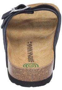 Black leather sandal with a cork footbed, adjustable strap with silver buckle, smooth texture, contoured shape, and stacked sole.