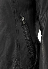 Schwarze Lederjacke mit seitlichem Reißverschluss, strukturiertem Oberflächenmaterial und sichtbaren Nähten. Der Reißverschluss ist aus Metall und verfügt über einen Zipper.