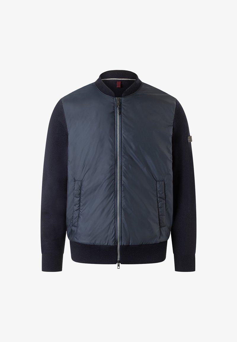 Giubbotto bomber navy con frontale trapuntato e maniche a maglia. Presenta un colletto e polsini a coste, oltre a due tasche frontali. Texture liscia.