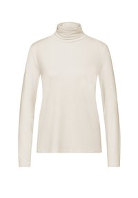 Haut en turtleneck en crème à manches longues fabriqué en tissu doux, avec un design ajusté, une texture lisse et sans motifs ni accessoires visibles.