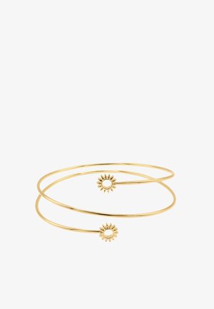 Bracelet jonc ouvert fin en or avec deux petites extrémités décoratives en forme de soleil, sur fond blanc.