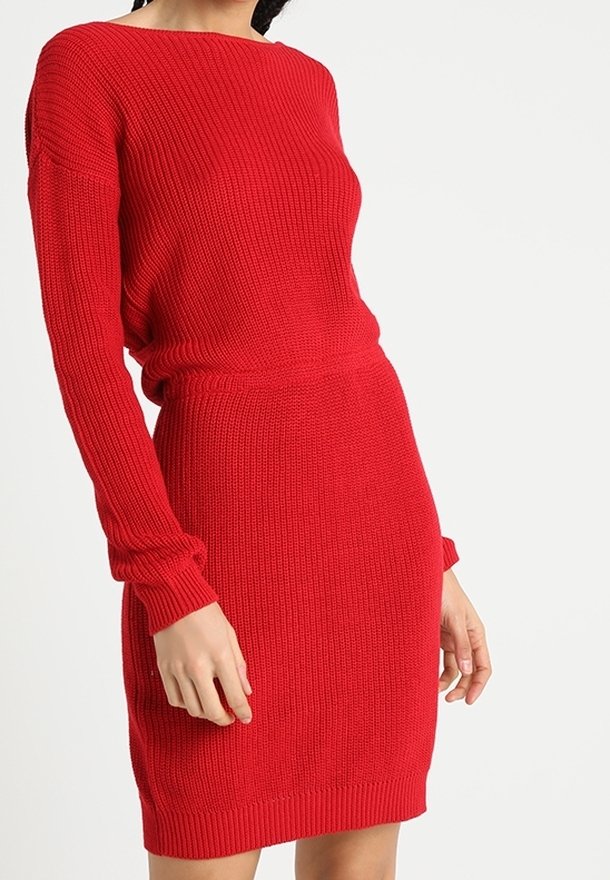 Vestido de punto rojo con mangas largas, textura acanalada, silueta ajustada y escote redondo, con una longitud a mitad del muslo.