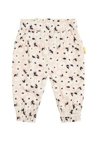 Leggings rose clair avec un motif floral en noir et blanc. Possède une taille élastique et des poignets froncés aux chevilles.