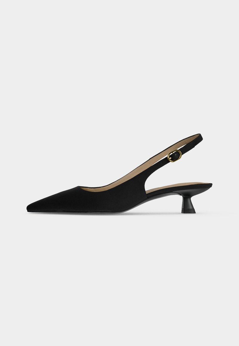 Black pointed-toe slingback shoe with a low kitten heel and gold buckle strap, shown in profile on a plain light background.