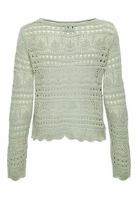 Jasnozielony, długi sweter dzianinowy z wzorami ażurowymi i falowanym brzegiem. Posiada teksturowane wzory oraz szeroki dekolt.