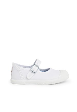 White canvas shoe with a rounded toe, buckle strap, and textured rubber sole. Features a blue checkered lining and a colorful label on the heel.