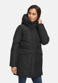 Black padded coat with a high collar, featuring a zip closure, horizontal quilt lines, and a belted waist design. Soft, textured fabric.