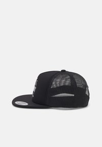 Black snapback cap with a solid front panel, mesh back, and a flat brim. Features a graphic print on the front.
