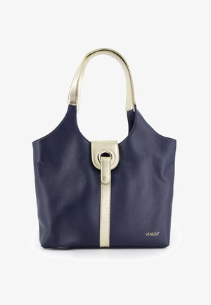 Marine læder håndtaske med guld accent og en cirkulær lås. Har en tekstureret overflade og en komfortabel skulderrem.