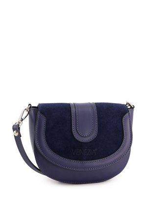 Navy blue bag combining smooth leather and textured suede, featuring a curved design, flap closure, and an adjustable strap.