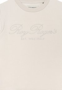 Felpa beige chiaro con logo bianco in rilievo "Roy Roger's EST. 1952 ITALIA" sul fronte; texture liscia, scollo tondo.