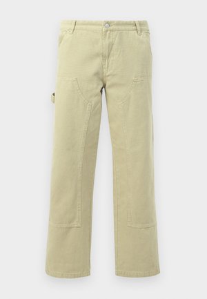 Beige katoenen wijde broek met voor- en zijzakken, met paneelstiksel en een riemlus op de tailleband.