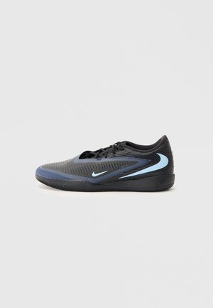 Black and blue low-cut athletic shoe with textured surface, black laces, and light blue Nike swoosh logos on side and sole.