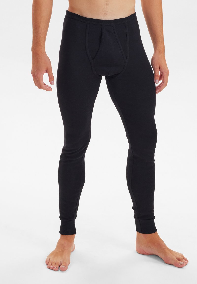 Black leggings made of stretchy fabric, featuring a front pouch and fitted design, with ankle cuffs and a smooth texture.