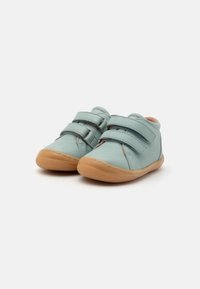 Light blue leather shoes with two Velcro straps, rounded toe, and tan rubber sole. Features stitched accents on sides.