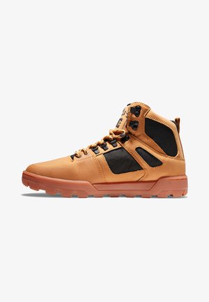 Brown leather mid-top shoes with black textile accents, lace-up design, and rubber outsole featuring textured grip pattern.