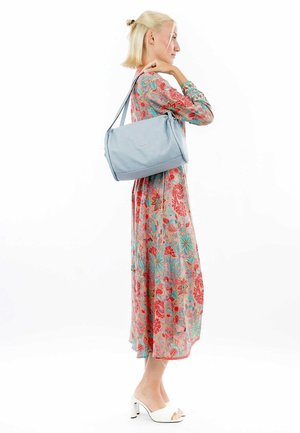 Light blue handbag made of textured material, featuring a rectangular shape, adjustable straps, and a smooth finish.