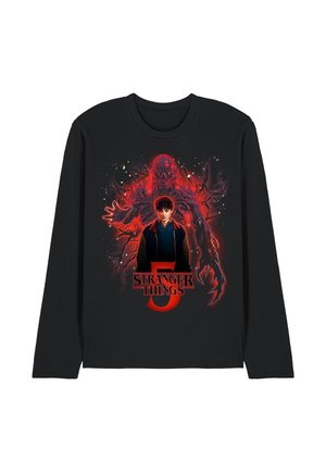 Black long-sleeve shirt with Stranger Things 5 design showing a boy in front of a large red glowing monster with clawed hands and tentacle-like arms.