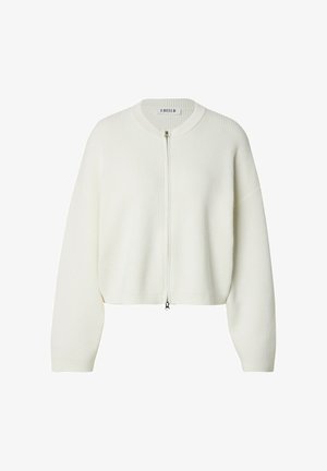White ribbed sweater with a cropped design, zip front closure, and dropped shoulders. Features a round neckline and soft texture.