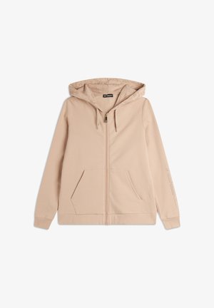 Sweat à fermeture éclair beige clair en tissu doux, doté d'une doublure de capuche à motifs, de poches avant et de poignets côtelés avec un logo.