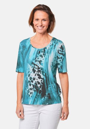 Korte mouwen top in teal met zwart-witte abstracte patronen; lichtgewicht stof met een ronde hals en een ontspannen pasvorm.