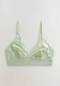Ljust grön bralette med spetsöverdrag i blommönster, justerbara satinband och en slät tygband under barmen.