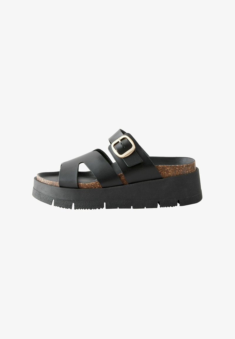 Black leather sandal with two wide straps, cork footbed, and a chunky black outsole. Features a gold buckle accent for adjustment.