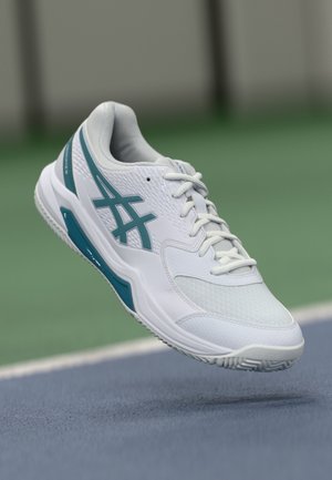 White athletic shoe made of mesh and synthetic materials, featuring teal accents, a textured sole, and a padded collar for support.