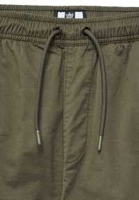 Shorts vert olive en tissu léger, dotés d'une taille élastique avec cordon de serrage et d'une poche latérale.