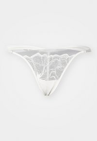 String en dentelle blanche avec un motif délicat de feuilles, doté de fines bretelles et d'une texture transparente. Le design est minimaliste et élégant.