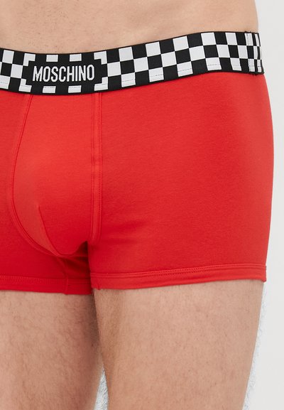 Red cotton boxer shorts with a black and white checkered waistband. Features a logo on the waistband and smooth, fitted design.