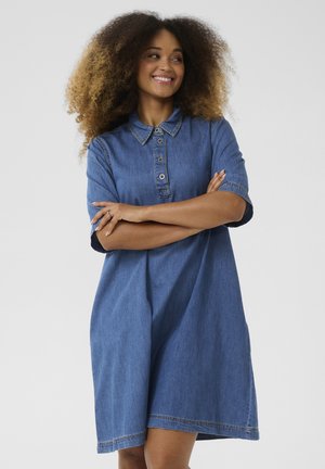 Denim shirt dress with a collared neckline, short sleeves, and a loose fit. Features buttons down the front and visible stitching details.