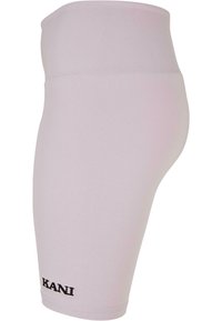 Világos rózsaszín leggings, magas derékkal. Rugalmas anyagból készült, kis fekete "KANI" logóval az alján. Simább textúra.