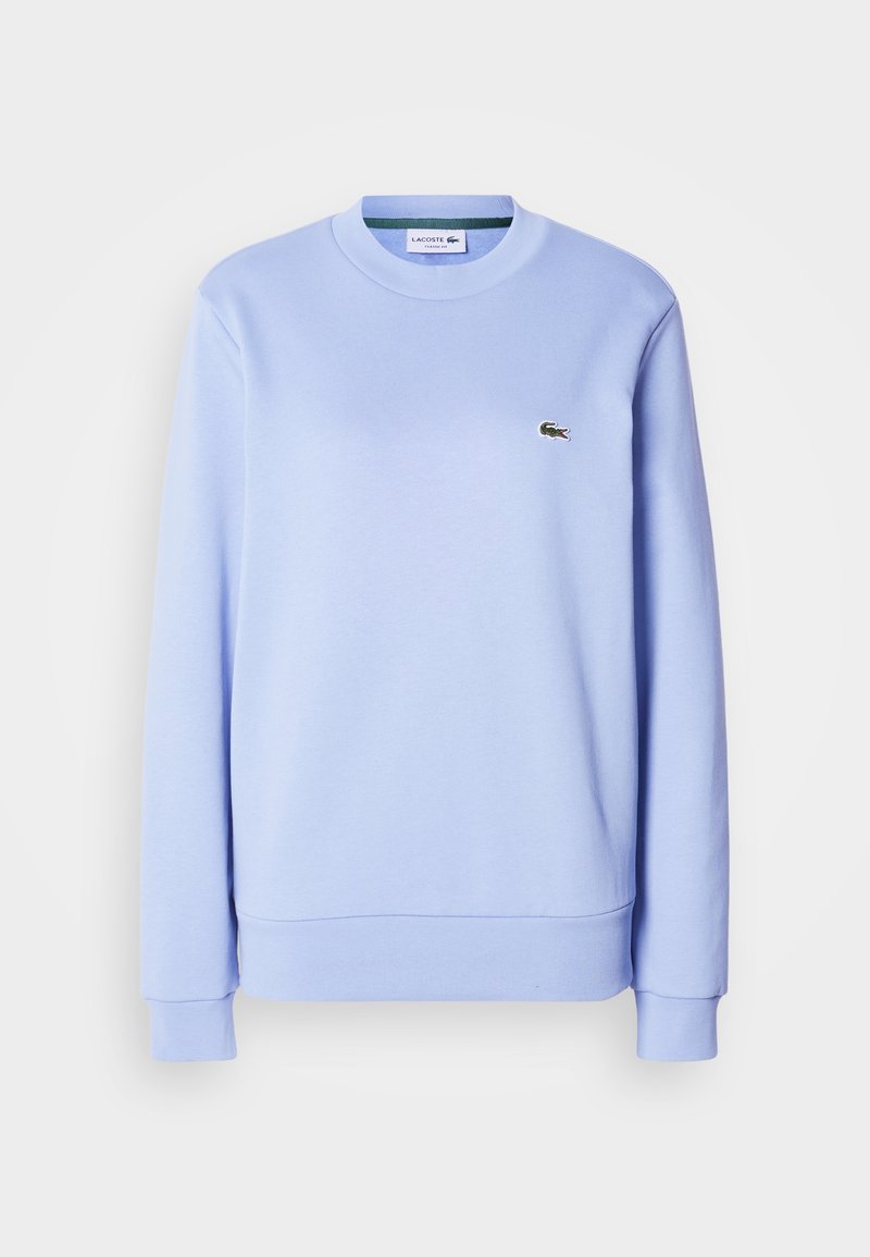 Sweat-shirt bleu clair à manches longues avec col rond, petit logo crocodile vert sur la poitrine gauche et poignets et ourlet côtelés.