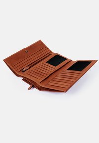 Brown leather wallet with a zip compartment, multiple card slots, and two clear ID windows. Textured interior and snap button closure.