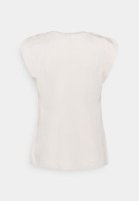 Ljusbeige, kortärmad topp med avslappnad passform. Slätt bomullstyg, rundad halsringning och något sänkta axelsömmar. Inga mönster.