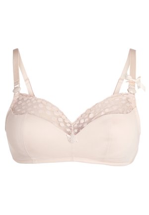 Soutien-gorge sans fil en beige doux avec panneau en dentelle et motif à pois sur le haut. Bretelles réglables et détail de nœud décoratif au centre devant.