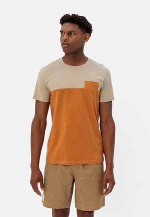 Short-sleeve tee featuring a beige and orange split design, with a chest pocket. Made of soft, textured fabric.