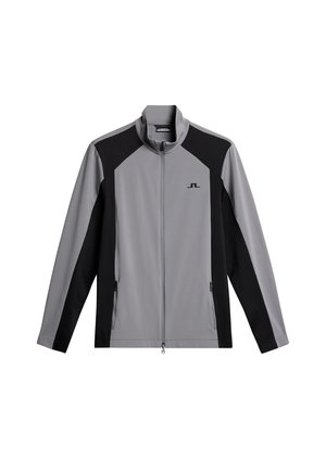 Gray and black zip-up jacket, featuring a high collar, paneled design, two side pockets, and a logo on the chest. Smooth, athletic material.