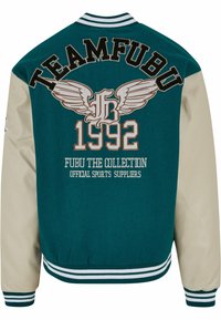 Jachetă de tip varsity teal și bej, cu broderie "TEAMFUBU" și un design cu aripi. Mânecile și tivul sunt cu nervuri, iar anul "1992" este afișat proeminent.