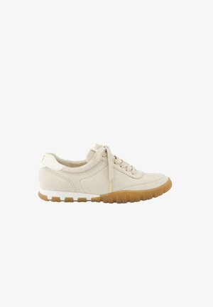 Beige suede sneaker with round toe, lace-up design, textured surface, rubber outsole in tan, and white accents on heel and sides.