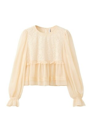 Camicia lunga a maniche lunghe color crema con corpino in pizzo, maniche a sbuffo trasparenti, cucitura arricciata in vita e polsini elasticizzati.