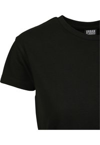 T-shirt en coton noir à manches courtes, avec un col rond et une texture lisse. Présente une étiquette logo au niveau du col.