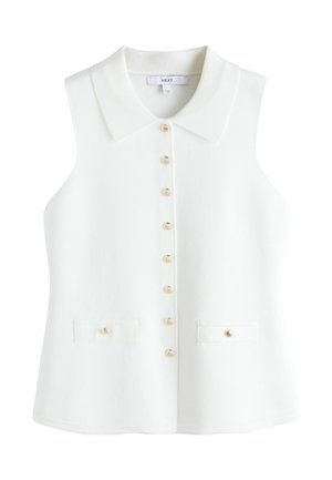 Ärmellose weiße Strickweste mit weitem Kragen, goldfarbenen muschelförmigen Knöpfen vorne sowie an zwei Vorderentaschen.