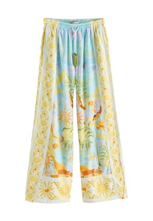 Light blue wide-leg pants with a tropical pattern. Features green and yellow sun motifs and a drawstring with colorful tassels.