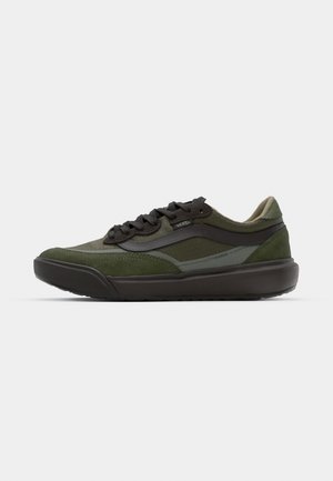 Green sneaker featuring a mix of suede and mesh materials, black laces, and a textured sole with a grey accent stripe.