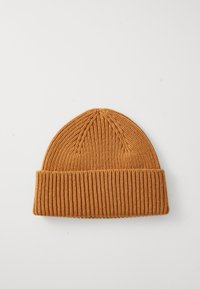 Rust orange ribbed knit beanie hat with folded brim, displayed flat on a white background.