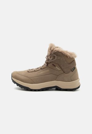 Brown high-top hiking boot with fur collar, rugged black sole, lace-up front, and Gore-Tex label on the side.